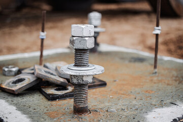 Construction site featuring various bolts and hardware during a building project in the afternoon...
