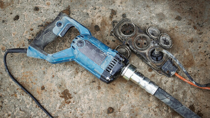 Power tool and accessories resting on a concrete surface during home renovation project © Anoo