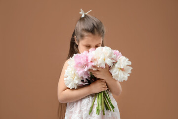 Cute little girl with bouquet of beautiful peonies on brown background