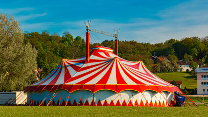 Spring landscape with a red and white circus tent on a sunny day at Postmuenster, Rottal Inn, Bavaria, Germany