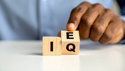 Hand Arranging Wooden Blocks Spelling Out the Term EQ Intelligence Quotient Concept