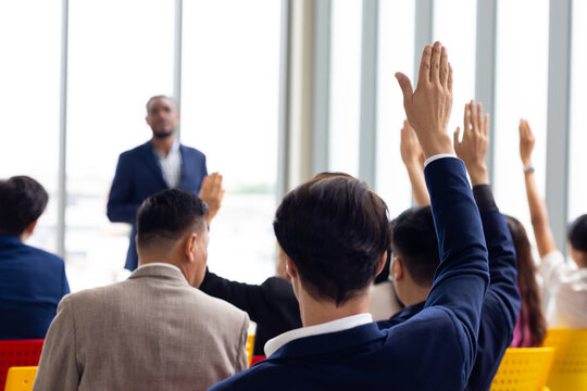 Question and answer audience or crowd : Active participation Asian man raise hands to ask questions attending seminar in conference meeting and training