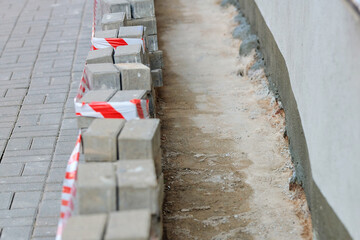 Foundation upgrade on aged building with paving removed and hydro insulation applied to prevent...