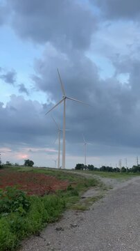 Wind Turbines on Rural Landscape Under Dramatic Sky at Dusk