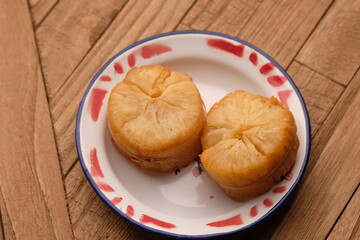 fried cassava on a zinc vintage plate. Cassava is a staple food and one of the sources of...