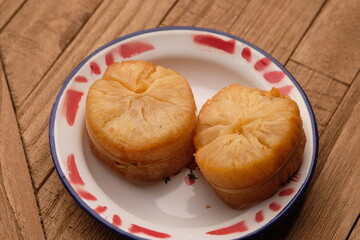 fried cassava on a white ceramic plate. Cassava is a staple food and one of the sources of...