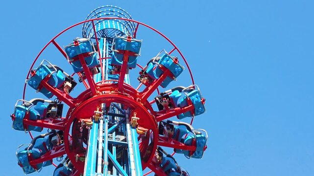 People free falling from tower ride at amusement park. Famous attraction Free Fall Tower in the amusement 