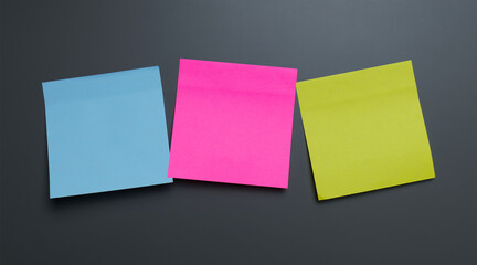 Colorful sticky notes arranged on a dark surface