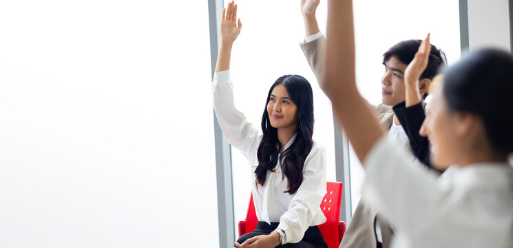 Question and answer audience or crowd : Active participation Asian woman raise hands to ask questions attending seminar in conference meeting and training - Powered by Adobe