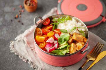 Healthy meal  container Buddha bowl with chicken, rice and vegetable salad. Back to school concept