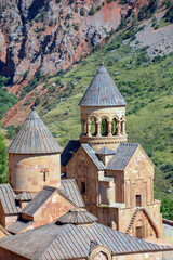 Church and beautiful natural landscape. Monastery in nature. Armenian Apostolic Church Noravank. Beautiful architecture of the church. Monastery against the backdrop of rocky mountains. Christianity i