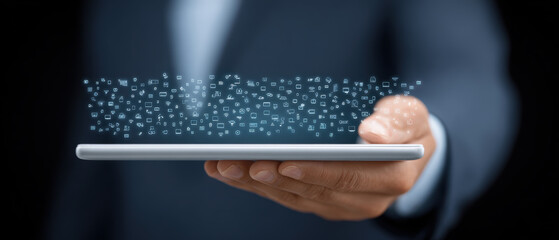 Person in suit holds tablet with digital icons floating above it, symbolizing technology and communication