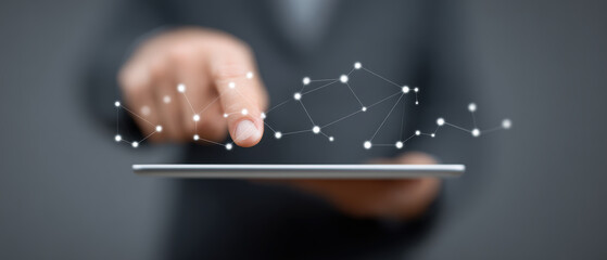 Person interacts with digital network interface on tablet, symbolizing connectivity and technology