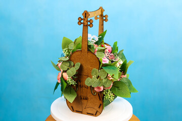 fragrant bouquet of soap roses in a violin-shaped flowerpot is a unique gift for the holiday.