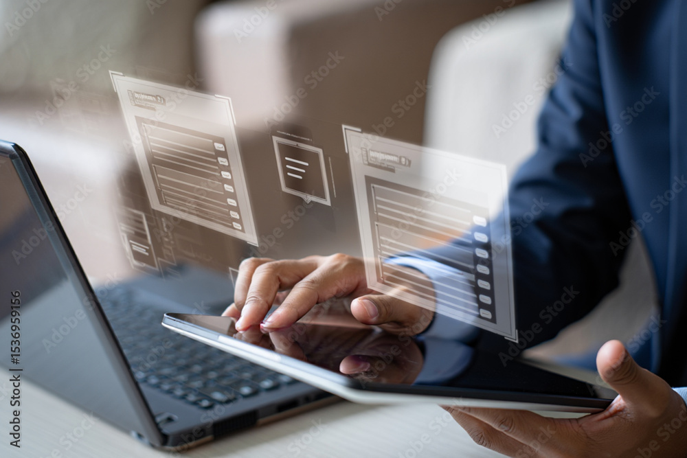 Poster businessman using tablet and laptop with holographic interface showing data and ui design