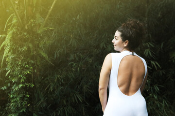 Happy woman in tropical forest, space text copy