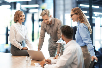 Business team discussing together business plans in office.