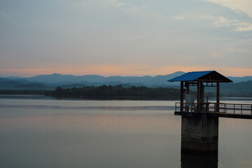 The house of controller for water level in the reservoir with layers of mountains in background