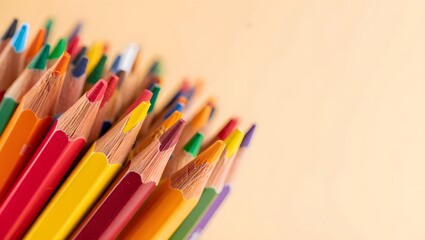 Fototapeta premium A closeup shot shows many colored pencils arranged together, their sharpened tips pointing upwards, showcasing a variety of bright hues