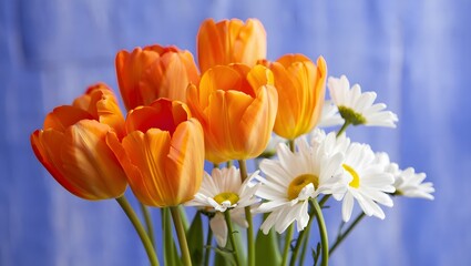 A vibrant bouquet of orange tulips and white daisies arranged together