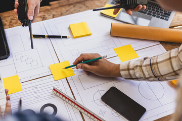 Team of architects and engineers working on construction project. Architect and engineer are using...