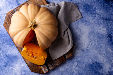 Raw fresh cut pumpkin on dark background
