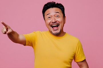 Excited Asian Man Pointing in Yellow T-Shirt