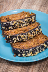 Pastry made of zucchini with nuts and raisin on plate. Delicious dessert