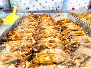 Delicious traditional dessert made with layers of pastry and nuts in a bakery displaying sweet dishes