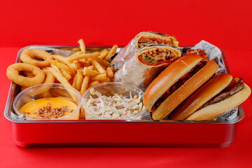 American food set - burger, french fries, shawarma, chicken wings, cheese sauce, onion rings and cole slaw