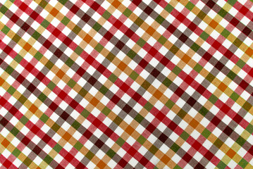 The texture of linen fabric in a large cage of red, green, brown and white. Scottish tailoring material. Checkered fabric