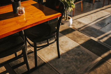 Wooden coffee shop table in the sunny setting sun