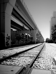 Obraz premium Elevated railway runs above train tracks 