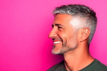 Obraz premium Conceptual art of style for aging men. Classy men's wavy fringe haircut - midlife arabian man with short hair. Pink solid background. An expressive and modern man in a studio setting.