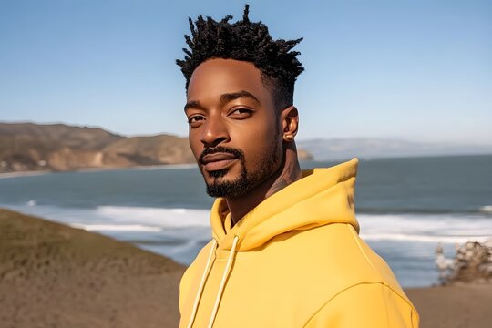 Handsome Man in Yellow Hoodie at Beach Seascape
