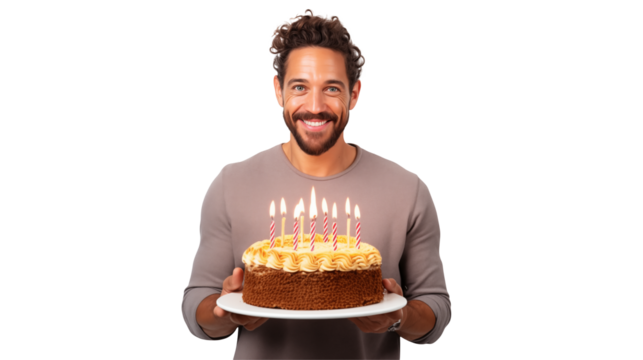 Man smiling holding a birthday cake with lit candles on a white plate against a transparent background