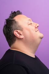 Fototapeta premium Idea artwork idea of style for aging men. Purple solid background. Modish men's high fade haircut - midlife white man with black hair. An expressive and modern man in a studio setting.