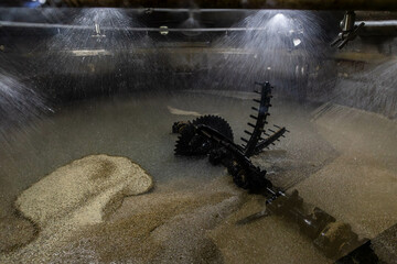 the process of mashing in a whisky distillery - the grist is mixed with hot water in a sugary liquid
