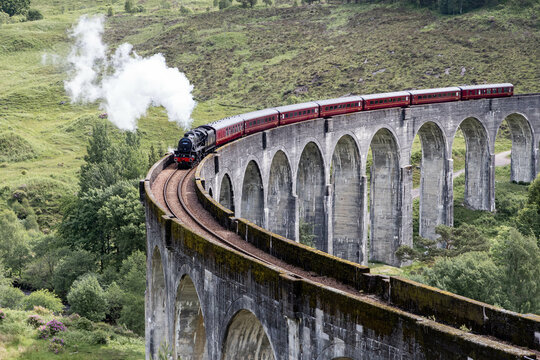 Glenfinnan, Scotland: The Jacobite steam train on the viaduct, known from several movies, also known as the famous Hogwarts Express in Harry Potter