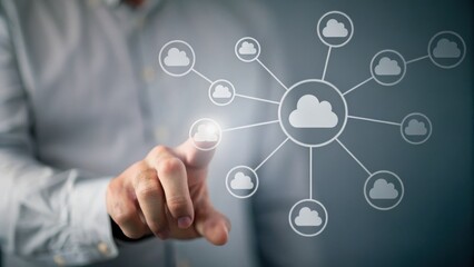 A man interacts with a virtual cloud network interface, symbolizing cloud computing and connectivity.