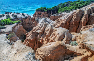 beautiful beach in the Atlantic Ocean bordered by hard sand cliffs forming a canyon Medides beach in Portugal