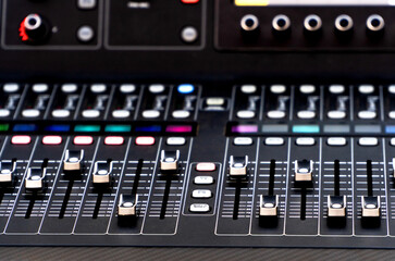 Close up of soundboard faders during a summer music festival show