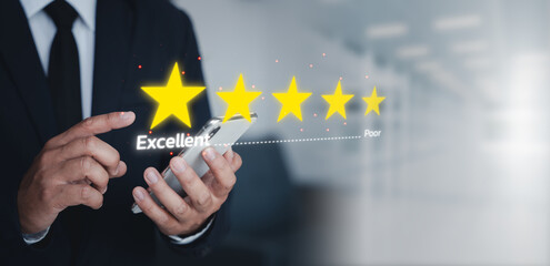A businessman rating five stars on a smartphone, symbolizing customer feedback, satisfaction, quality service, and trust in a digital environment