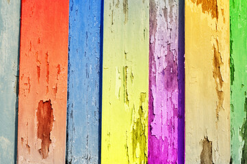 Multi color on wooden plank background.