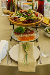 served table, glasses, plates, vase with forge