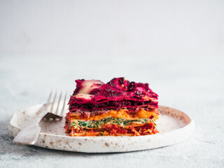 Vegetable Packed Rainbow Lasagne on craft plate.Ideas and recipes for healthy vegetarian dinner or...