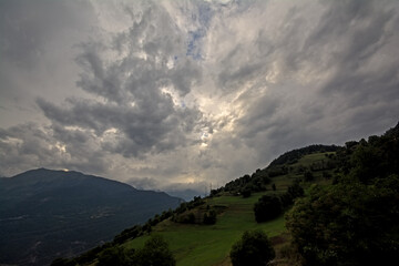dark stormy clouds over silhouette of mountains in Vanoise national park, France 