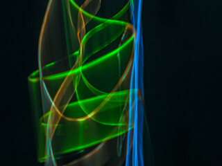 colorful light trails in dark background. Abstract light routes that rotate in vibrant colors. Forestry of the blurry movement of light painting. Blurred lights at night. Intentional camera movement,	