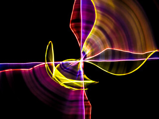 colorful light trails in dark background. Abstract light routes that rotate in vibrant colors....