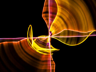 colorful light trails in dark background. Abstract light routes that rotate in vibrant colors....
